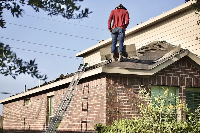 Professional roofer working on a residential roof in Lamont